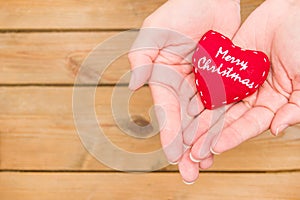 Hand with a heart with the message Merry Christmas