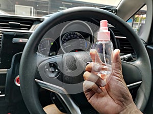Hand-held alcohol Spare  Before holding the steering wheel  The concept of Covid 19.â€‹ Bangkokâ€‹ Thailand,24 Marchâ€‹ 2020