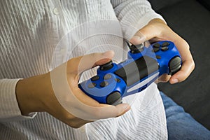 A hand that held Joystick controller was playing a video game