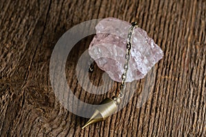 Hand-held pendulum on a chain with a natural crystal photo