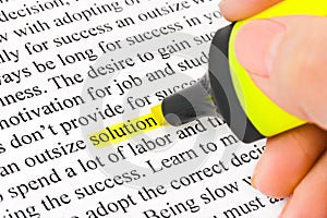 Hand with highlighter and word solution photo
