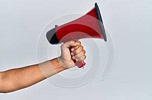 Hand of hispanic man holding megaphone over isolated white background