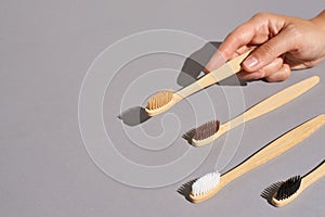 Hand hold bamboo eco tooth brush. Grey background