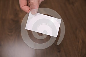 Hand hold blank white card mockup with rounded corners. Plain call-card mock up template holding arm. Plastic credit namecard