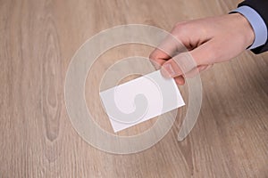 Hand hold blank white card mockup with rounded corners. Plain call-card mock up template holding arm. Plastic credit namecard