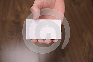 Hand hold blank white card mockup with rounded corners. Plain call-card mock up template holding arm. Plastic credit namecard