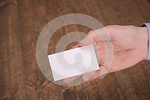 Hand hold blank white card mockup with rounded corners. Plain call-card mock up template holding arm. Plastic credit namecard