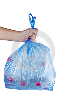 Hand hold blue plastic garbage bag with used PET bottles isolated on white background