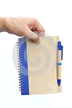 Hand hold brown notebook