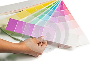 A hand hold colored swatches for choose paint samp