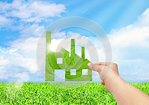 Hand hold factory iconon field and blue sky background, Eco gree