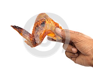 Hand hold grilled chicken wing