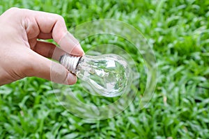 Hand hold incandescent bulb photo