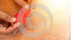 Hand holding a red color puzzle jigsaw. concept of missing a key success