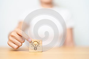 hand hold lightbulb block with business Idea, strategy, innovation , creativity, learning, brainstorming and success concept