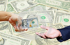 Hand hold many US Dollar with US Dollar banknote background.