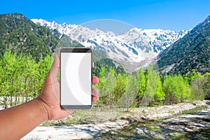 hand hold mobile phone on a view of japan alps mountain, Japan