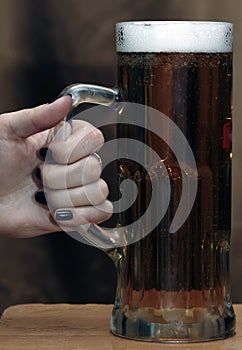 Hand hold mug of beer