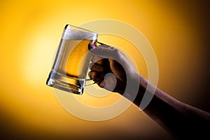 Hand hold mug of beer