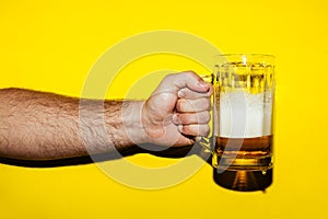 Hand hold mug of beer