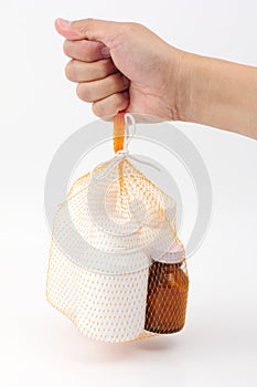 Hand hold the net bag medicine bottle