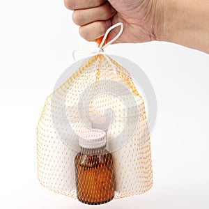 Hand hold the net bag medicine bottle