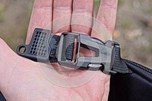 hand hold a one closed black plastic carabiner