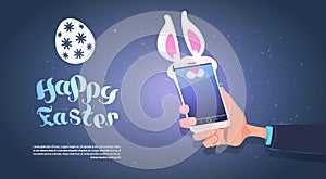 Hand Hold Smart Phone With Bunny Ears Happy Easter Background With Copy Space