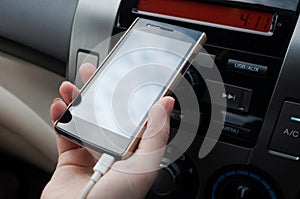 Hand hold smartphone in car,Charger plug phone on car