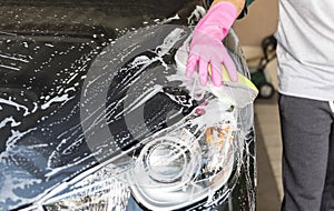 Hand hold sponge over the car for washing