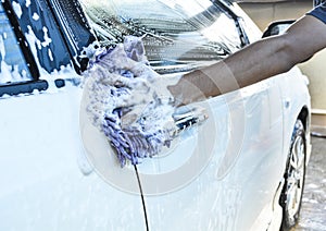 Hand hold sponge over the car for washing