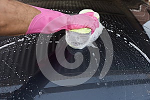 Hand hold sponge over the car for washing