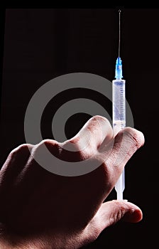 Hand hold a syringe