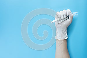 Hand hold syringes on blue. screen background