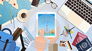 Hand Hold Tablet Computer With Dubai Skyline Panorama, Traveler Workplace With Passports Top Angle View