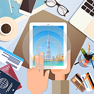 Hand Hold Tablet Computer With Dubai Skyline Panorama, Traveler Workplace With Passports Top Angle View