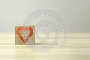 Hand hold wooden cube with heart sign icon on and copy space