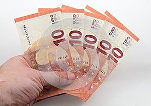 Hand holding 10 Euro notes