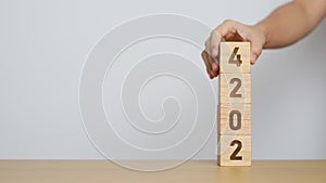 hand holding 2024 year block on table. goal, Resolution, strategy, plan, start, budget, mission, action, motivation and New Year