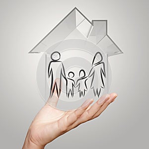 Hand holding 3d house wtih family icon