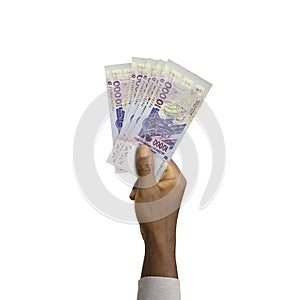 Hand holding 3D rendered 10000 West African CFA notes isolated on white background