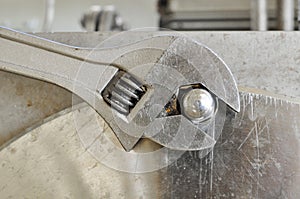 Hand holding adjustable wrench