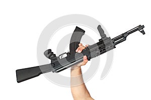 Hand holding AK-47 machine gun