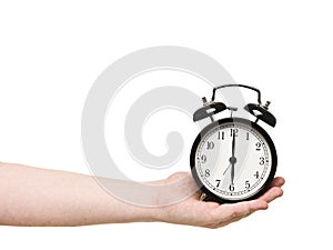 Hand holding alarm clock