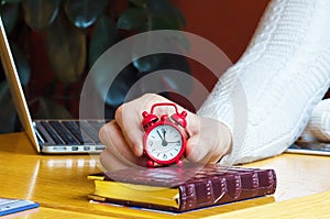 Hand Holding Alarm Clock and Pointing  Break Time Concept, telework
