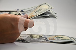 Hand holding American Cash, Dollars in hand on a white background