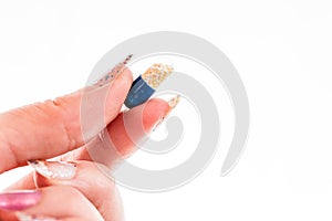 Hand holding antibiotics capsules or painkillers isolated on white. Medicine concept, pills close up, copy space