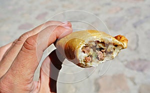 Hand holding an argentinean empanada photo