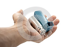 Hand holding asthma inhaler equipment