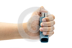 Hand holding asthma inhaler equipment.Pharmaceutical product for treat and prevent wheezing and shortness of breath and